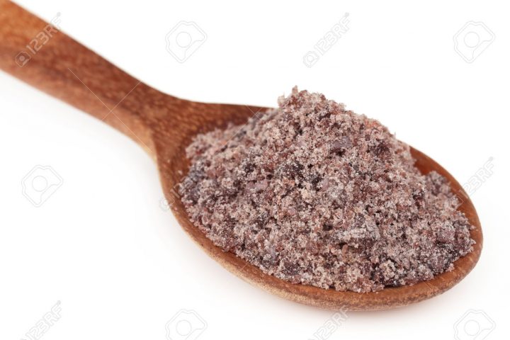 Kala namak or Black salt of South Asia on a wooden spoon